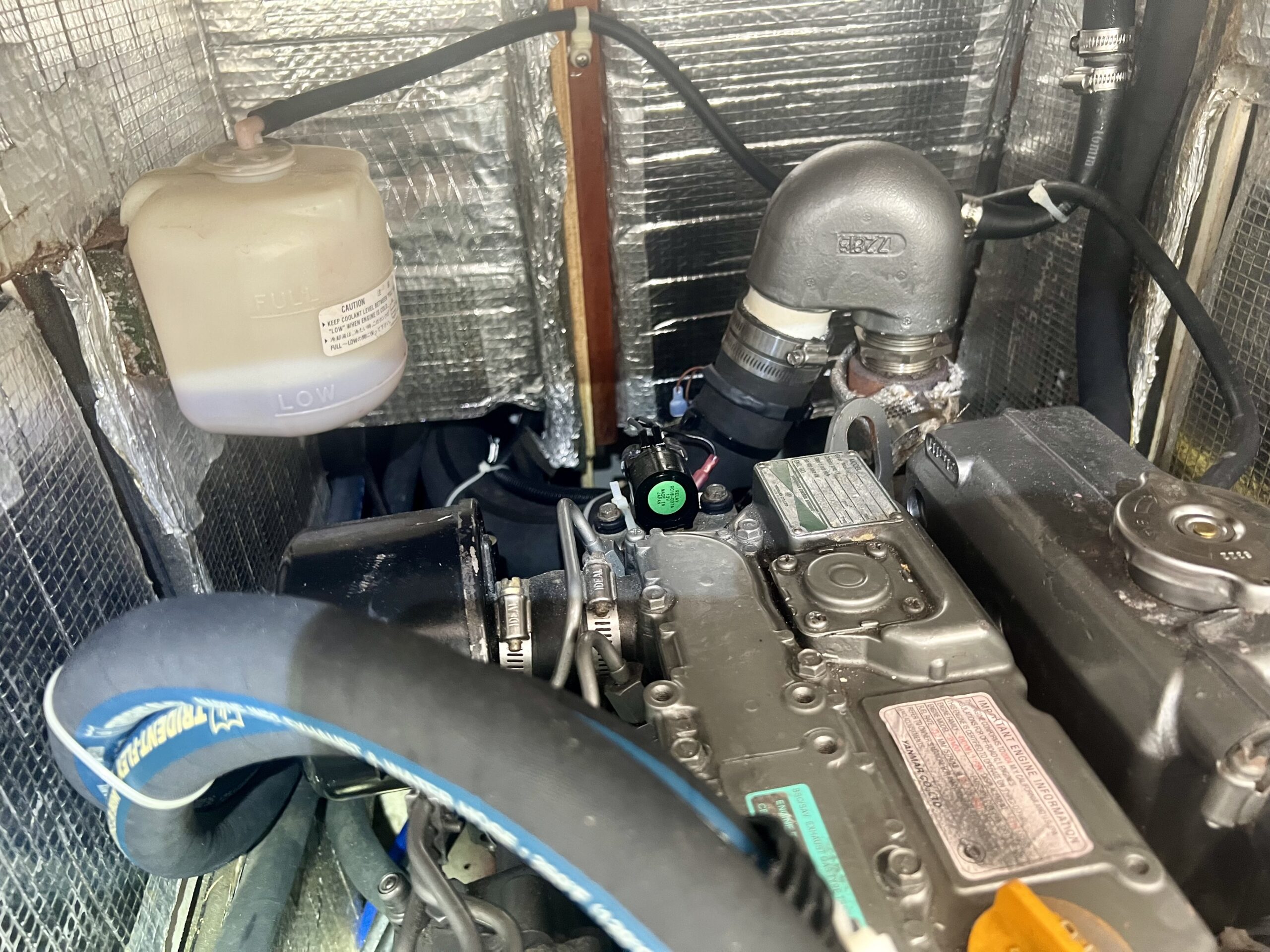 Marine-grade insulation installed in a boat engine compartment